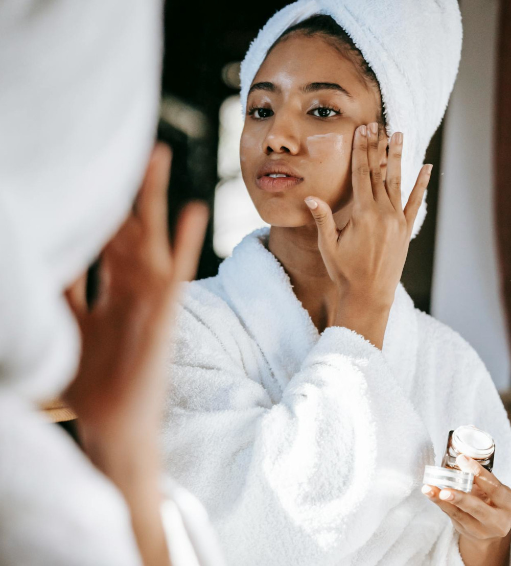 Woman applying skin care product